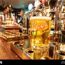 A pint of lager on a pub table.