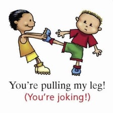 One person playfully pulling another person's leg.
