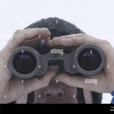 A person looking at a distant object through binoculars