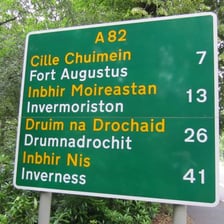 A road sign in a Scottish Highlands setting.