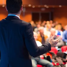 A person speaking to an audience