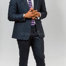 A person standing with a confident, dignified posture.