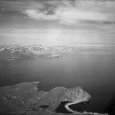 An aerial view of a coastal bay partly enclosed by land