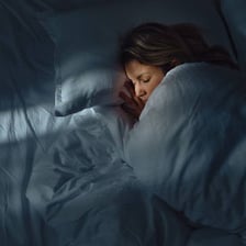 A person resting in bed while ill