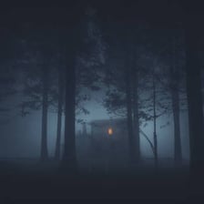 A shadowy house surrounded by fog at night