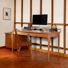 A desk arranged as a workspace with writing supplies.