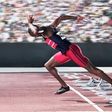 A runner moving rapidly on a track