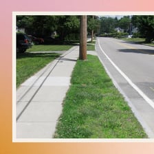 A raised street curb bordering a pavement