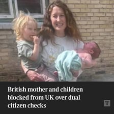 A mother standing with her child.