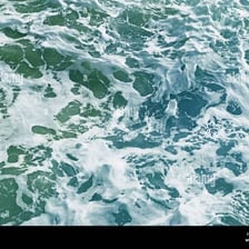 Blue seawater washing over a sandy shore
