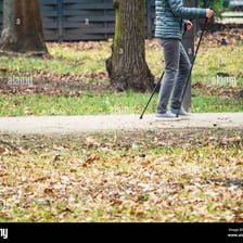 A person walking slowly along a park path