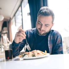A person looking hungrily at a meal