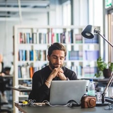 A person stopping work at a desk