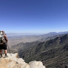 A hiker continuing up a difficult uphill trail