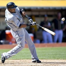 A player striking a ball with a bat.