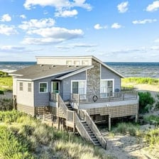 A house standing beside a sandy beach