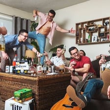 A group of young men behaving in a boisterous, playful way.