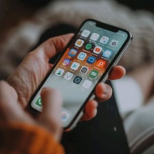 A modern mobile phone held in a person's hand
