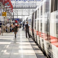 Passengers arriving at a railway station.