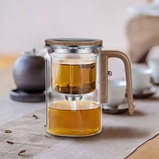 Tea leaves releasing colour and flavour into hot water