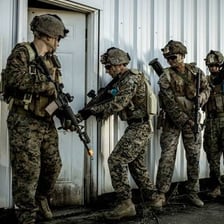 Soldiers taking part in combat on a battlefield.