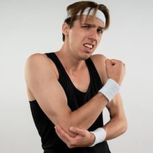 A person giving another person a gentle elbow nudge
