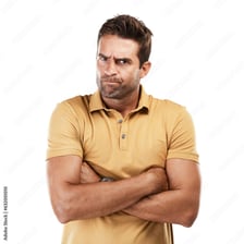 An annoyed person standing with folded arms.
