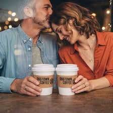 Two people meeting across a café table.