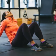 An exhausted person sitting down to recover after strenuous activity