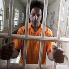 A view through the bars of a prison cell