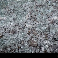 Broken glass scattered across a floor.