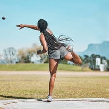 A person in the act of throwing a ball