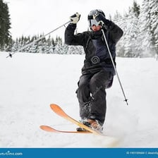 A skier gliding downhill over snow.