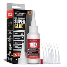 A small bottle of super glue being used to bond two objects