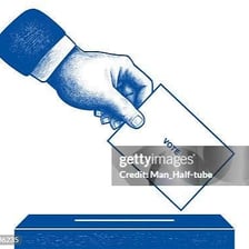 A voter placing a ballot in a ballot box