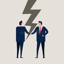Two people withdrawing from a handshake after a disagreement