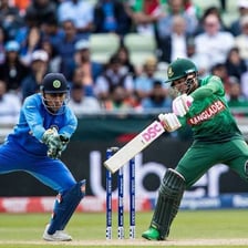 A cricket ball passing the batsman and wicketkeeper.