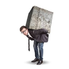 A person struggling to carry a heavy load