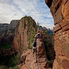 A person approaching a dangerous narrow mountain path.