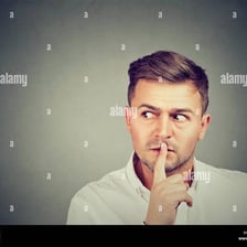 A person quietly signalling to get another person's attention
