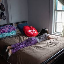 A person separated from others in a quarantine room.