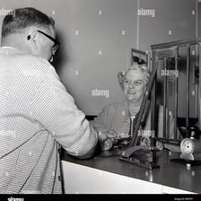 A person placing a wager at a betting counter.