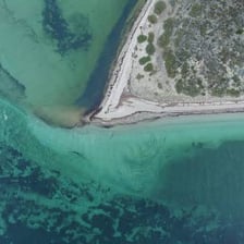 An aerial view of a narrow coastal inlet