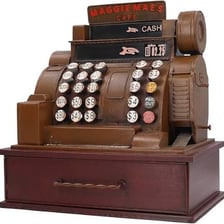 A traditional retail cash till on a shop counter.