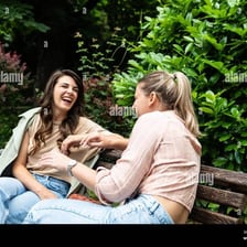 Two friends chatting together outdoors