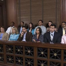 A courtroom jury box occupied by jurors
