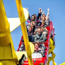 Passengers experiencing an exciting roller coaster ride