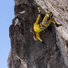 A mountain climber persevering on a steep ascent