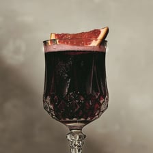 A glass of dark purplish-red claret wine