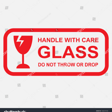 A glass vase being handled carefully to avoid breakage.